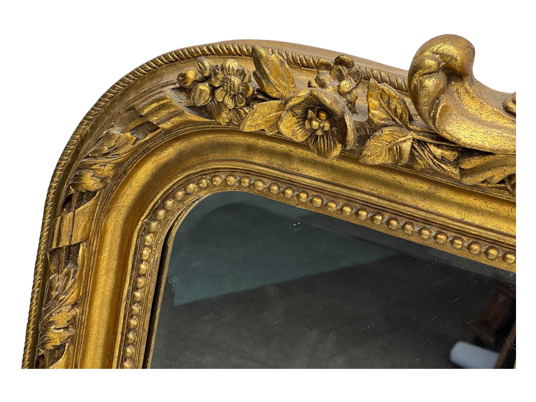18th century design ornate gilt framed overmantle mirror, bevelled mirror plate within arched frame with pierced pediment featuring foliate and scrollwork designs