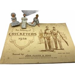Two albums of cricketing cigarette cards by Players and Wills; three unopened early packets of cigarettes; quantity of empty cigarette packets; coal carving; and other collector's items