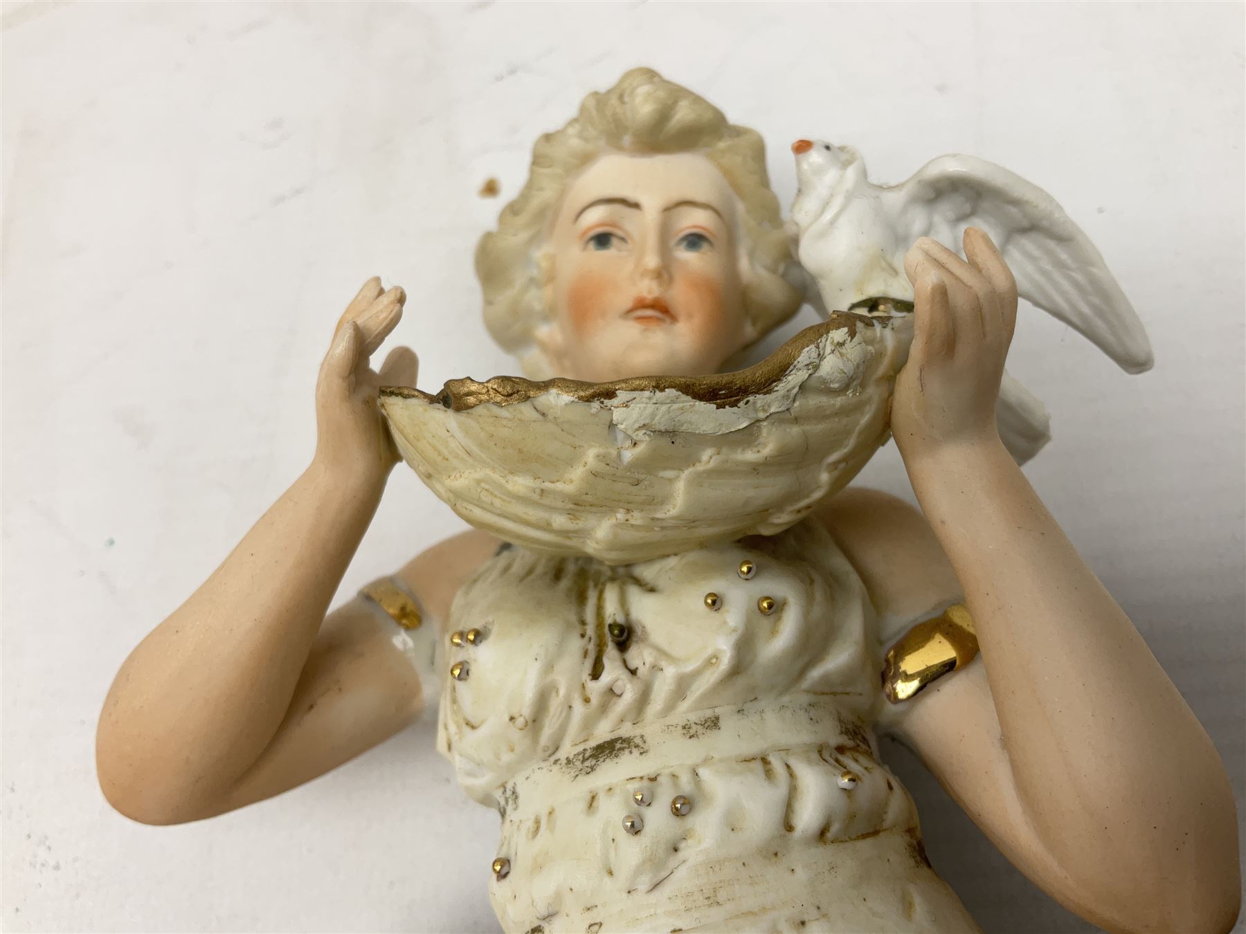 Late 19th century continental spill vase as a young girl standing beside an open tree trunk H21cm; and three German bisque figures (4)