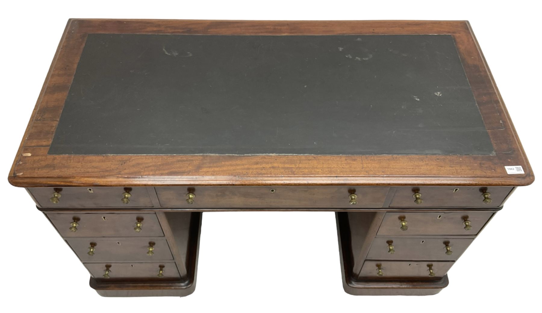 Victorian mahogany twin pedestal desk, rectangular top with inset ebonised leather writing surface, fitted with nine graduating drawers with brass pull handles, on plinth bases