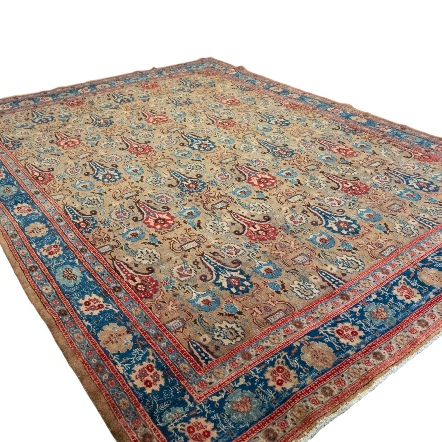 Central-Western Persian Sarouk hand-knotted carpet, beige ground, with an all-over design of boteh and floral sprays in red and blue within a floral border on blue ground 