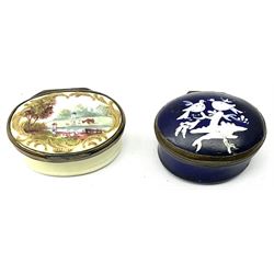 Georgian enamel patch box of oval form, the hinged cover decorated with two doves upon a branch, opening to reveal mirror beneath cover, together with a later enamel patch box, the hinged cover decorated with a figure in a landscape. (2). 