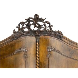 Early 20th century Italian walnut armoire wardrobe, the pierced and scrolling pediment carved with acanthus leaf detail, flanked by two scrolling cartouche with matching corbels below, the two panelled doors with applied carved rinceaux slips, with a central spiral turned upright, enclosing single shelf and hooks, raised on scroll feet