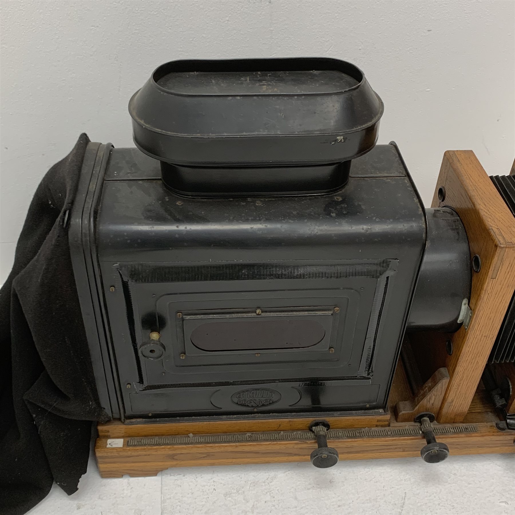  Very large oak and brass magic lantern style enlarger, the black japanned lamp housing with embossed Ernemann Dresden plaque, rack and pinion focusing, two folding bellows, rise-and-fall and pivoting facilities and Ross London 5