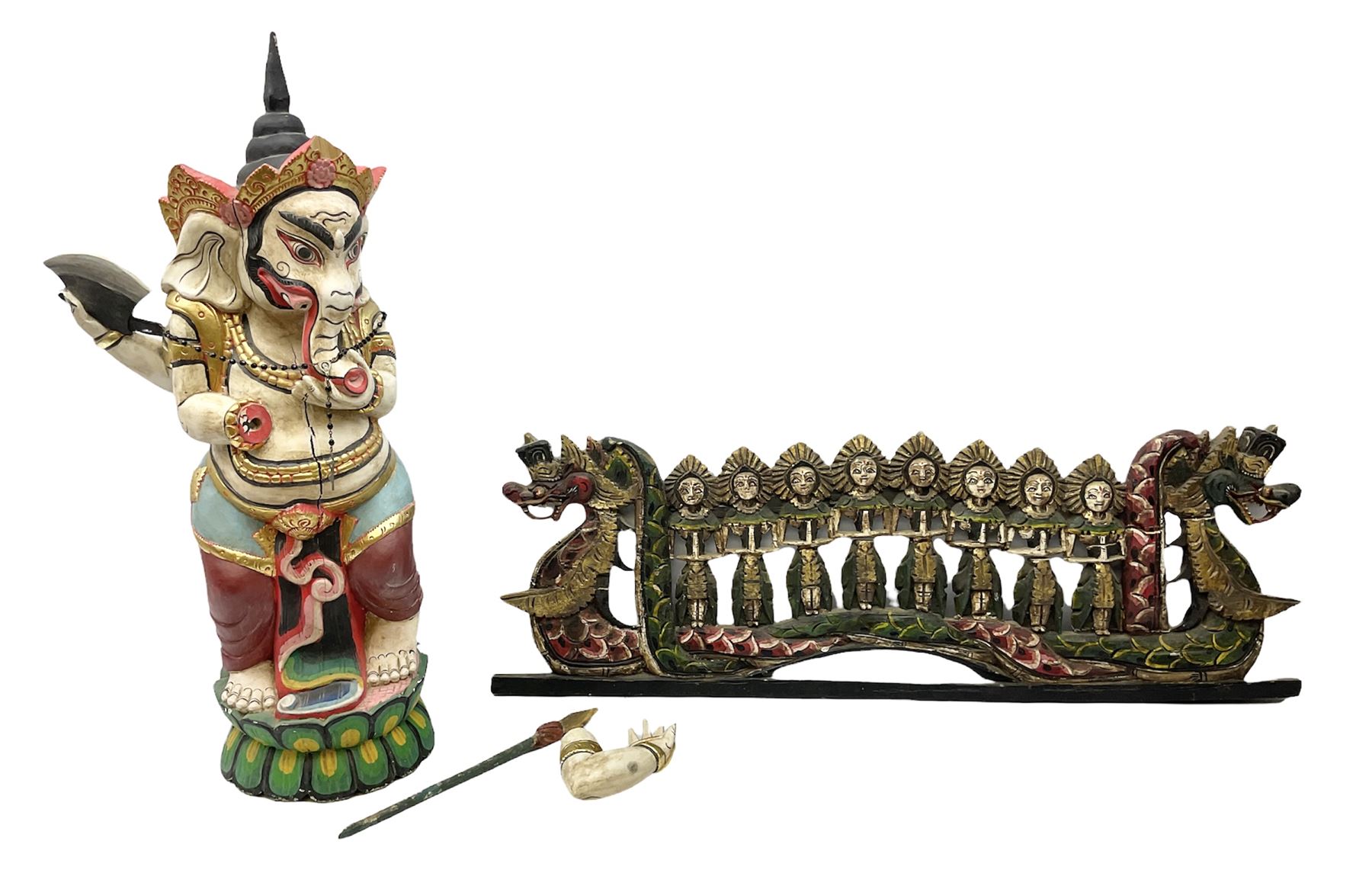 Balinese wood wall panel carved as a dragon boat with passengers, painted in reds and greens with gilding, together with a carved wood figure of Ganesh Deity decorated with gilt, raised upon circular lotus flower plinth, H78cm
