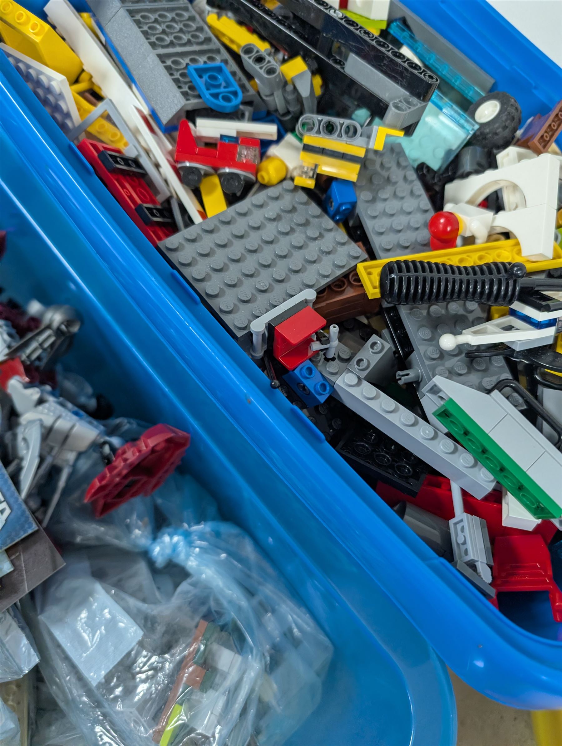 Collection of Lego, including built Bionicles Mistika models with instructions, loose Lego pieces, Lego Beatles Abbey Road canvas print and a Lego head storage box