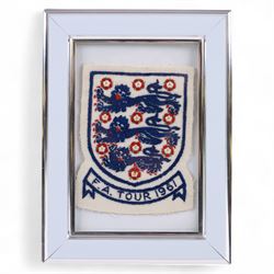 1960s three lions embroidered cloth badge from an England football shirt, reading F.A. Tour 1961, framed