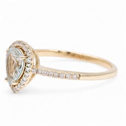 18ct gold aquamarine and diamond cluster ring, single pear cut aquamarine of approx 0.80 carat, surrounded by round brilliant cut diamonds and diamond set shoulders, London 2015