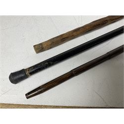 19th century painted bamboo walking cane, the handle carved as a fox with glass eyes, with gilt metal stamped LB, together with an ebonised wooden walking stick, with horn pommel and hallmarked silver collar and a curved wooden walking stick, with monogrammed white metal cap, tallest L90cm