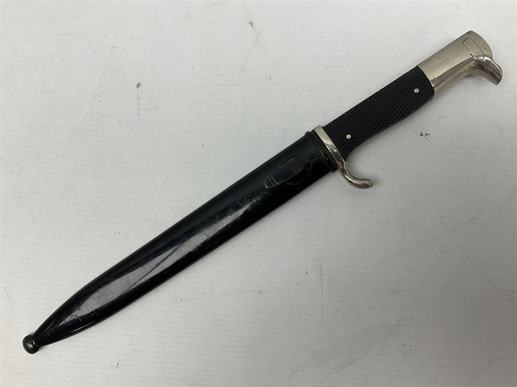 German Wehrmacht KS98 dress bayonet, with plain 19.5cm fullered blade marked Anton Wingenje Solingen, chequered black plastic grip and original leather washer to ricasso; in black painted metal scabbard L36cm overall