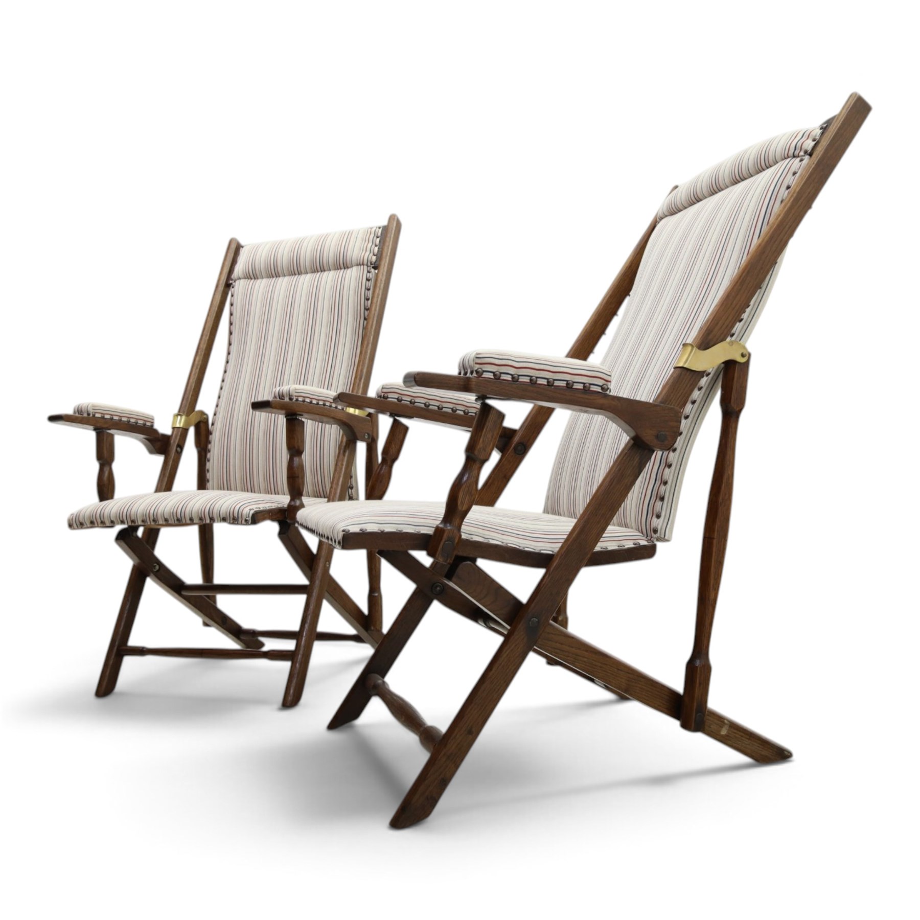 Pair of early 20th century oak framed garden reclining and folding deckchairs, high back and seat upholstered in striped fabric with padded armrests