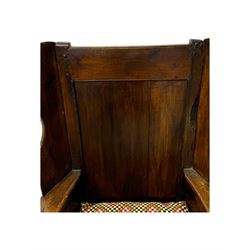 George III oak lambing chair, tall rectangular panelled backrest with shaped wings over broad scrolled armrests, box seat with removable geometric upholstered cushion, integrated drawer to lower section, resting on square supports