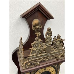 20th century Dutch style Zaanse Zaandam wall clock with a German eight-day weight driven movement housed in a wooden case on a shelf bracket, with a brass effect chapter ring and cherub spandrels, striking the hours and half-hours on a bell, with weights and a pendulum, H52cm
