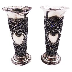 Pair of Edwardian silver vases, each of tapering cylindrical form with flared and crimped rim, upon spreading circular foot, the body pierced and embossed with vacant panel, birds, dog and hare in chase, putti, flower heads and acanthus scrolls, hallmarked Goldsmiths & Silversmiths Co Ltd, London 1903, with blue glass liners, H17cm, approximate silver weight 6.70 ozt (208.5 grams)