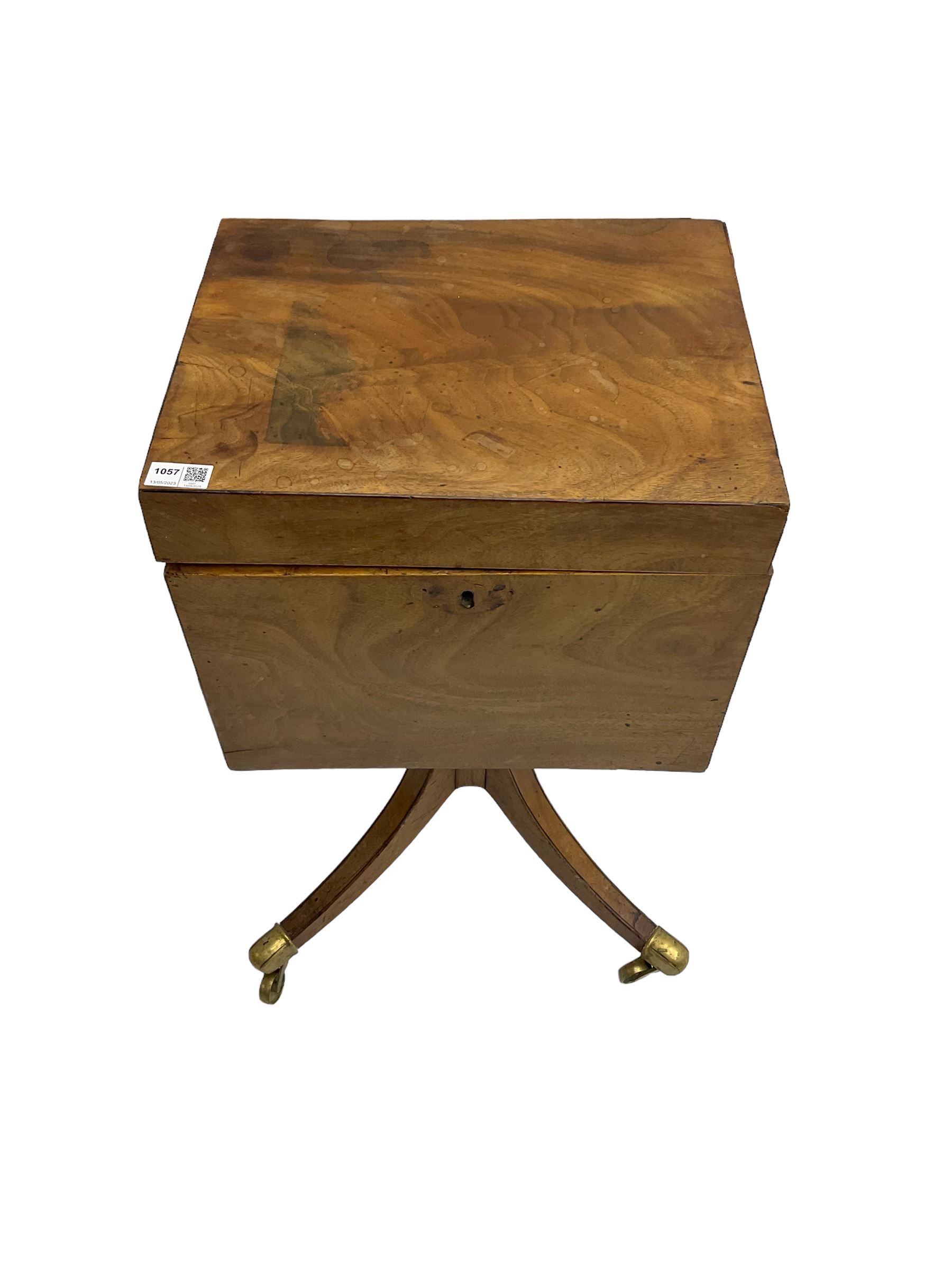 Regency mahogany cellarette on stand, rectangular top with hinged lid, raised on turned pedestal terminating in quadrupod base with brass cups and castors