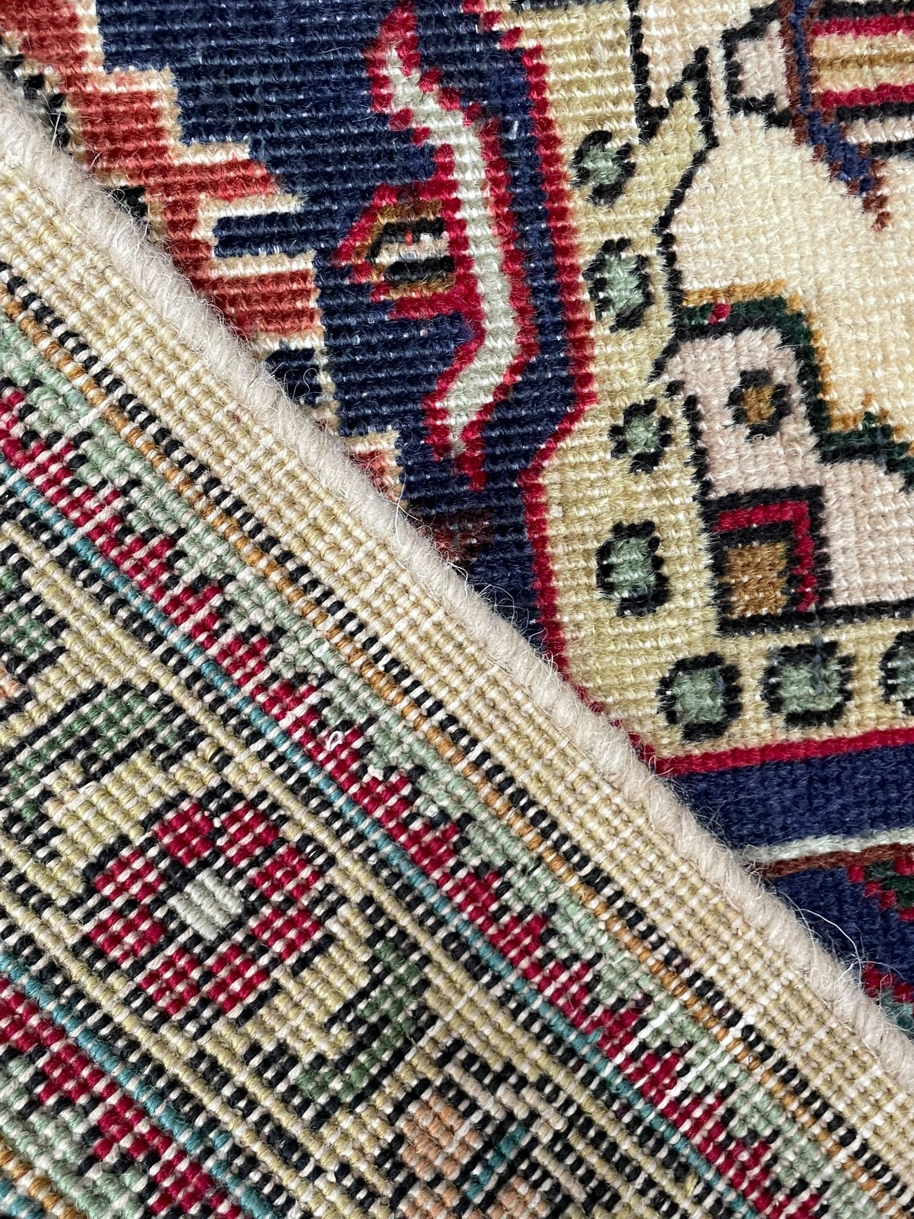Persian Heriz pale wheat ground rug, indigo pole medallion surrounded by neatly arranged Hac and stylised flower head motifs, indigo main border decorated with alternating palmette motifs, within floral pattern guard stripes 