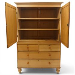 Victorian stripped pine housekeepers cupboard, projecting cornice over two panelled cupboard doors enclosing two shelves, the base fitted with two short over two long graduating drawers, lower moulded edge over turned feet