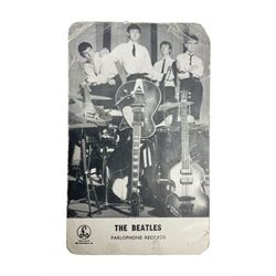 The Beatles - Parlophone Records promotional photographic card depicting a very young group standing together behind a pile of musical instruments; signed verso by George Harrison, Ringo Starr, Paul McCartney and John Lennon, inscribed by two members to 'Janet' and also signed by a female 'roadie' F. Holly who had been assigned to look after her 14.5 x 9cm
Provenance: The signatures were obtained by 'Janet', the vendor, at the Majestic Ballroom, Witham, Hull, at their performance on 13th February 1963, when she was sixteen years old. Janet was still recovering from being injured in a car accident so was removed from the packed audience to watch the performance from the wings where she acquired the signatures, personally watching each member of the band sign the card. Whilst signing the card the Beatles asked her to attend a party later that night at their hotel in Hull but she declined as she was too young and had to return home by 11pm!