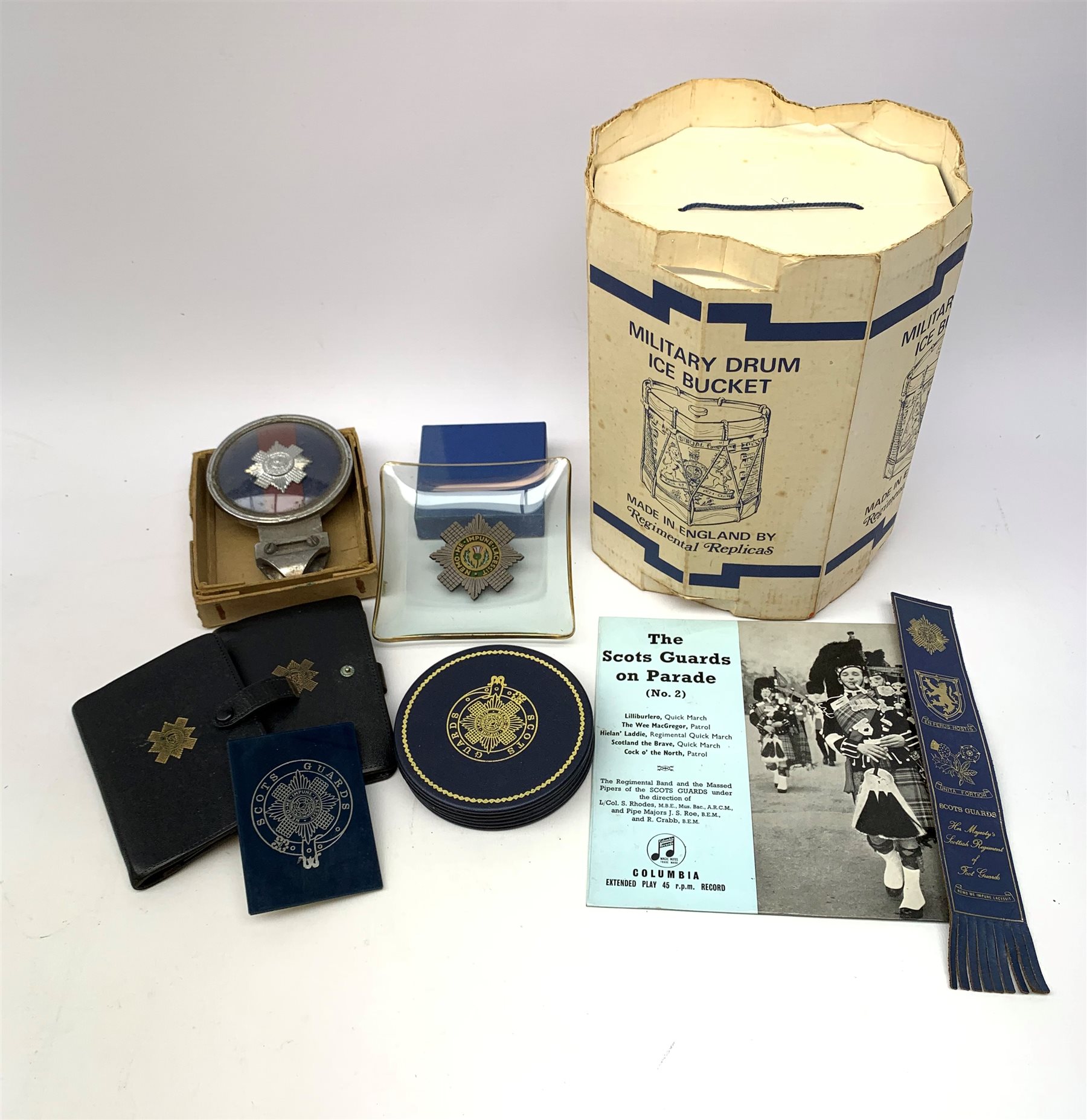 Scots Guards - three car badges by Beaulah, Gaunt etc; Military Drum Ice Bucket in original box; Regimental Crest on shield; boxed sets of table mats and coasters; two wallets; 45rpm record; ash trays etc