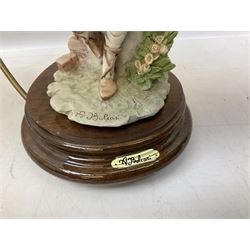 A Belcari figural table lamp, modelled as a young gent leaning upon brick wall, on turned wood base, signed, H70cm incl shade, together with bronzed figural table lamp of a lady with parasol upon ornate circular plinth base, two ceramic table lamps and another lamp (5)