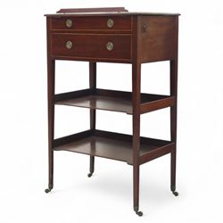 George III mahogany and boxwood-strung drawing table, the rectangular sloping reading surface with rest and oak stay, above a blind drawer and a drawer fitted with brass ring handles, side with pull-out candleholder and inkwell compartment, raised on square-section tapered legs with brass box castors united by two galleried under tiers