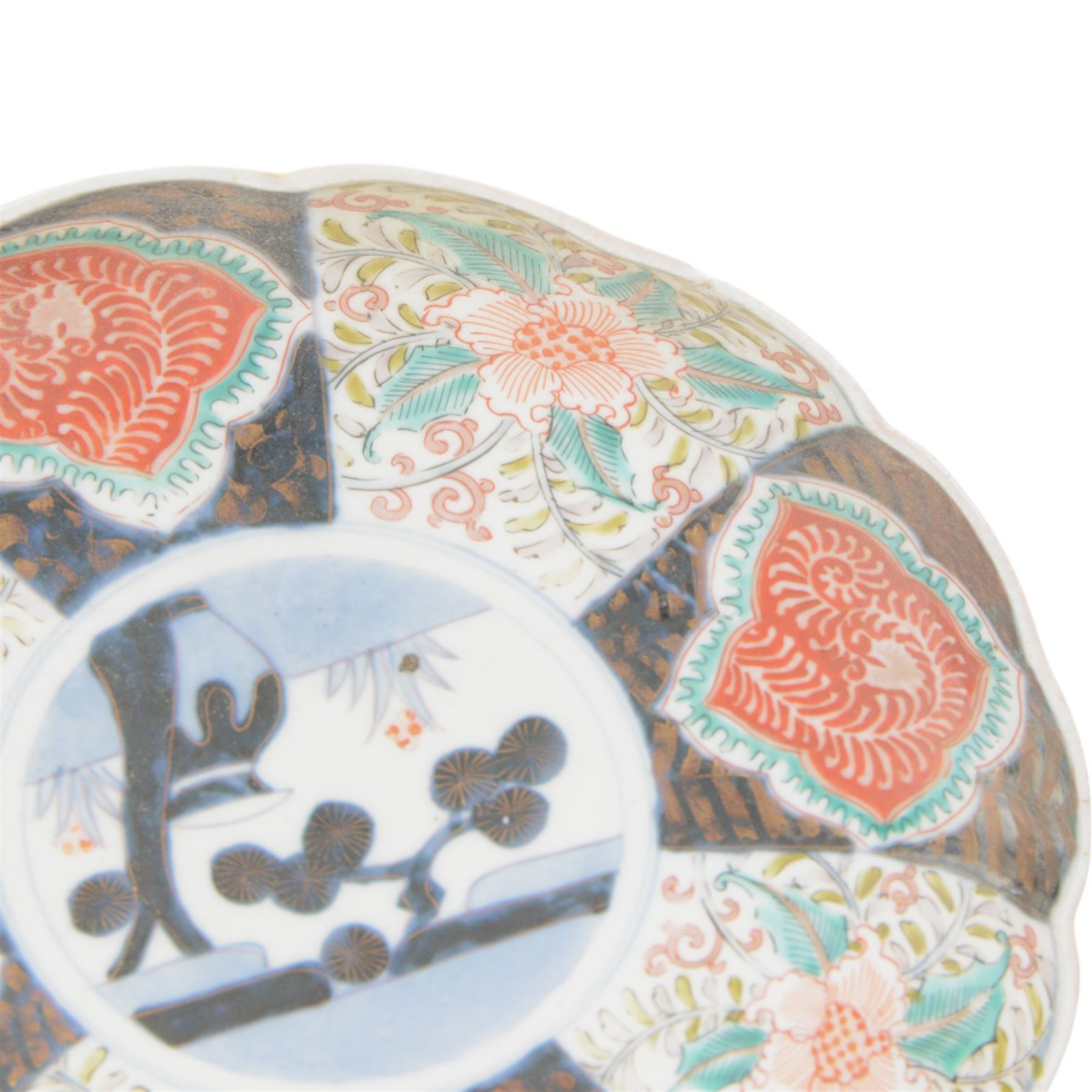 Group of 19th century Japanese Imari porcelain, Meiji period, comprising pair of lobed dishes, decorated stylised reserves and painels in blue and gilt upon a red ground, H6.5cm D21.5cm, a pair of plates of circular lobed form, decorated with a central panel depicting a vase beneath pine branches, and surrounded by panels of flowers and stylised quatrefoil shapes, D21cm, and another similar example painted with a character in underglaze blue to the centre, with character mark beneath, D22cm, each with character marks beneath               