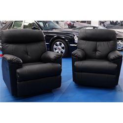 Two reclining armchairs upholstered in black faux leather