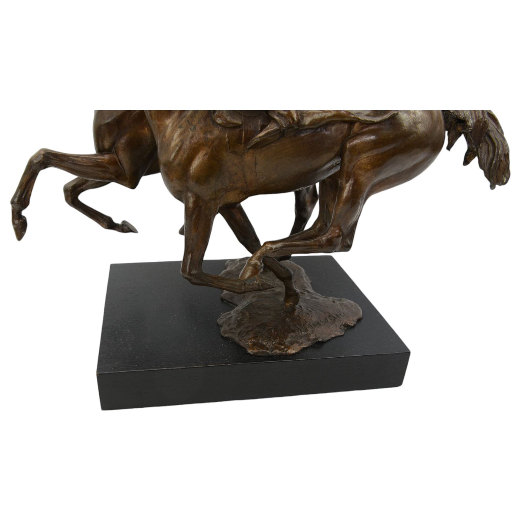 Bernard Winskill  (d1980) - 'Upsides on High Moor' a bronze group of two horses and riders, signed, on wooden base 45cm x 48cm