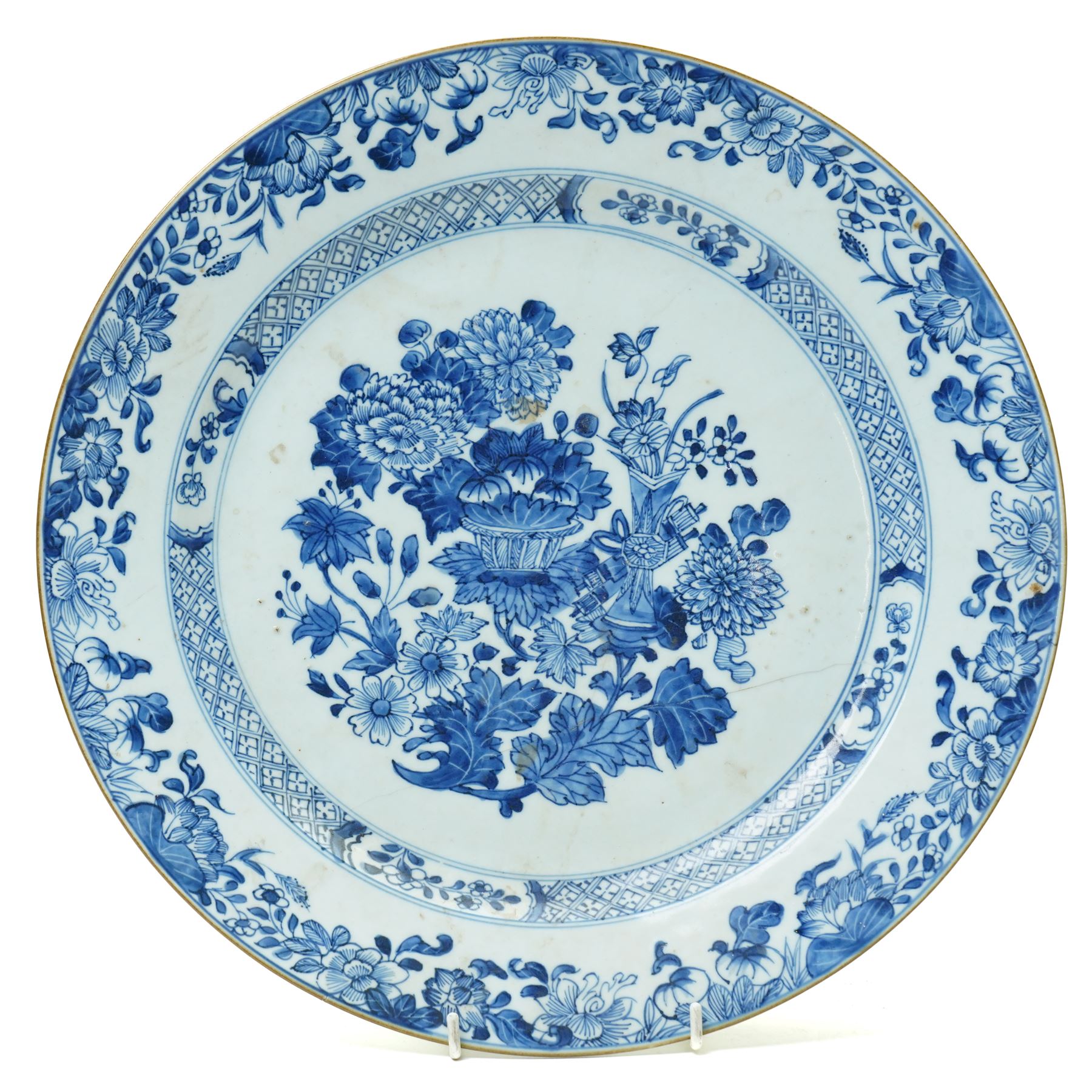 18th century Chinese oval dish shallow dish decorated with flowers in blue and white within a scroll and key pattern border W37cm and a Chinese blue and white charger D34cm (2)