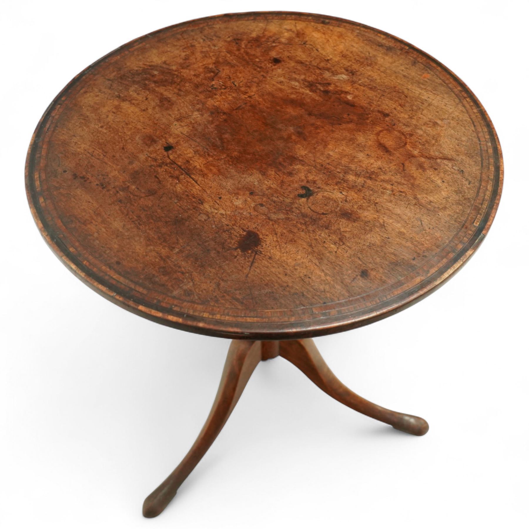 George III mahogany tilt-top tripod table, the circular top with moulded edge and inlaid edge, tilting on an iron catch above a ring-turned column, raised on three outswept legs terminating in pad feet