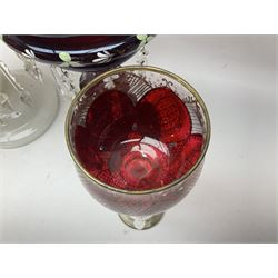 Bohemian red glass lustre, painted with stylised floral and foliate decoration, together with a milk glass example and two bohemian goblets converted to lustres 