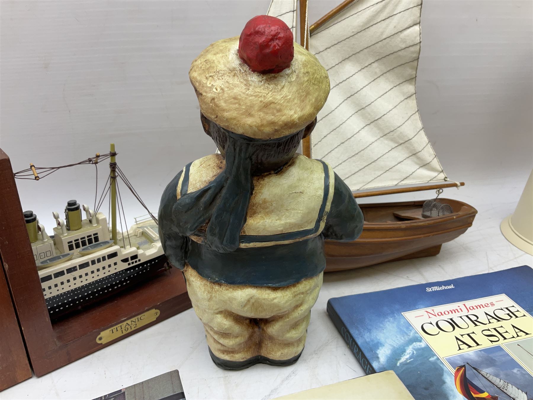 Nautical themed decorative items, to include Titanic book ends, model boat, books, lighthouse lamp etc in one box