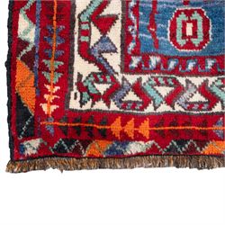 South-west Persian Lori rug, the red field centred by four linked stepped cruciform medallions with polychrome diamond centres, enclosed by a blue ground octagonal motif border, ivory angular meander band and red geometric outer border