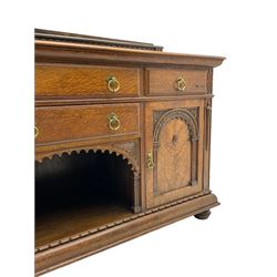 Edwardian oak sideboard, raised arcade carved back over rectangular top, fitted with four drawers, two arch carved doors doors flanking open arched centre, on turned feet