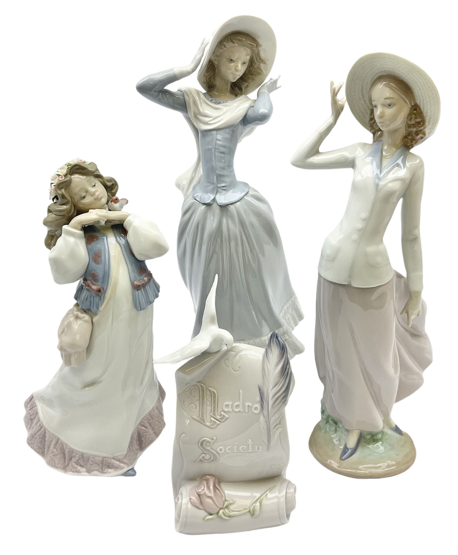Three Lladro figures, comprising, Dreams of Summer Past no 6401, Spring Breeze no 4936 and Breezy Afternoon 5682 together with Lladro plaque Art Brings us Together no 7677, all in original boxes, largest example H35cm
