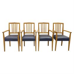 Modern twelve oak dining chairs including one 'Chairmans' chair, solid oak construction, slatted back and arm rests, blue leatherette padded seat, on tapered square supports 