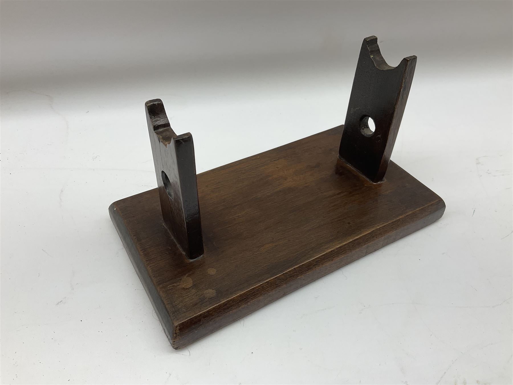 Early 19th century flintlock 16-bore overcoat/duelling pistol by William Bond Lombard Street London, the 23cm octagonal brown stub twist damascus barrel with small foresight, two barrel pins and ram rod under, inscribed Lombard Street London to the top and W. Bond to the action, full walnut stock with lightly engraved steel furniture, pineapple finial and escutcheon, half cock facility L39cm; loose mounted on later mahogany display stand with trade label