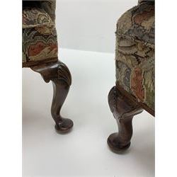 Matched pair early 20th century Queen Anne style wingback armchairs, walnut framed, sprung seats with seat cushions upholstered in needle work cover, shell carved cabriole front feet