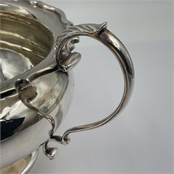 1920s five-piece silver tea service, comprising teapot, coffee pot, hot water pot, twin handled open sucrier and milk jug, each of squat circular form with shaped rim, the teapot, coffee pot and hot water pot each with ebonised handle and finial, the sucrier and milk jug with acanthus capped scroll handles, all upon circular foot, hallmarked R F Mosley & Co, Sheffield 1926 & 1927, tallest H24cm