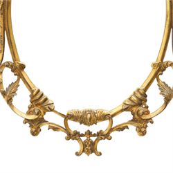 Rococo design giltwood and gesso wall mirror, oval plate within moulded frame, pierced cresting and apron, decorated with acanthus leaves, flowerheads and trailing foliage