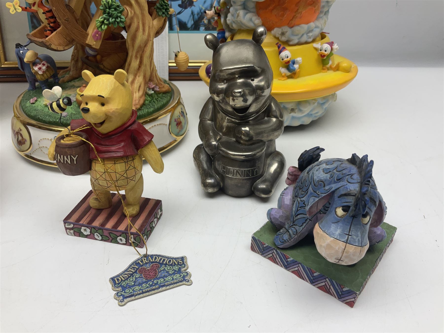 Collection of Disney figures, to include Ardleigh Elliott music box Hunny of the Day, Disney musical snow globe, Micky mouse lazy butler, Framed Bug's Life lithograph etc 