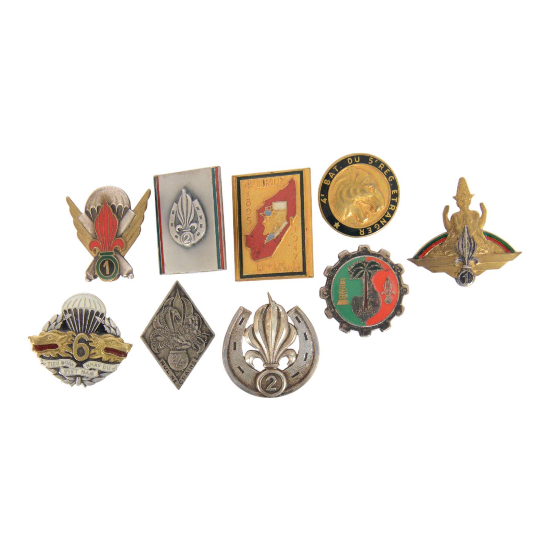 French Foreign Legion etrangere badges comprising seven  Kepi Blance Replacements and two Legion Cavalerie badges

