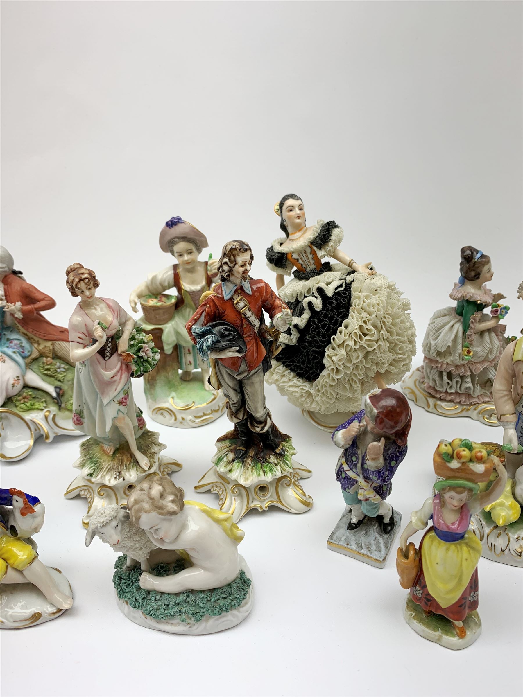 A group of various Continental figures, to include examples marked Dresden and Capodimonte, plus others with spurious blue cross marks beneath. (14). 