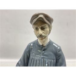 Lladro figure, Cookies for Sale, modelled as a male donning hat with pipe standing above a barrel containing a dial with its lid removed, sculpted by Salvador Furio, no 5191, with original box, year issued 1984 year retired 1985, H29cm  