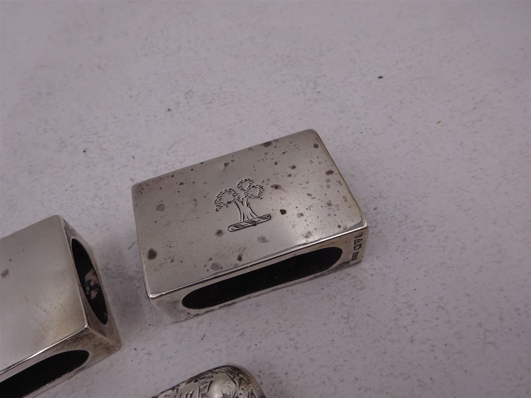 Pair of early 20th century silver matchbox covers, each of typical form, engraved with a tree to the centre, with personal engraving to reverse, hallmarked Stokes & Ireland Ltd, Chester, date letter worn and indistinct, together with a late Victorian silver vesta case, engraved with floral decoration, with monogrammed shield shaped cartouche to centre, hallmarked E V Pledge & Son, Birmingham 1900