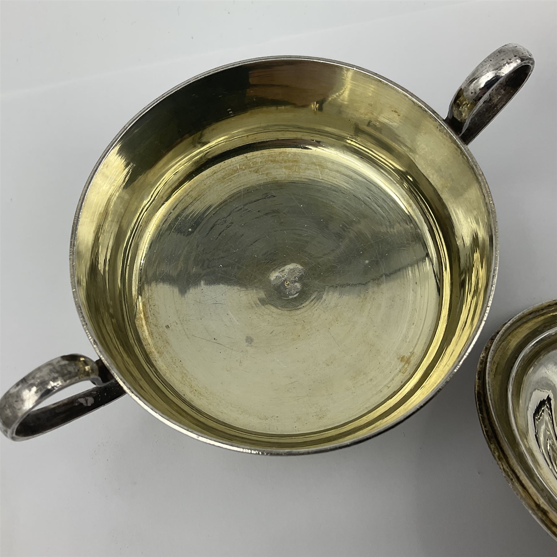 Early/mid 20th century Persian silver tea service, comprising circular serving tray, teapot, twin handled sucrier and cover, milk jug, five tea glasses with six silver holders, six tea spoons, and pair of sugar tongs, each profusely chased with foliate arabesque decoration, each bearing marks including 84 for 840 fineness, tray D40cm, teapot H16cm