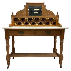 Late Victorian satin walnut washstand, raised bevelled mirror and tiled back carved with scrolled foliage, white marble rectangular top over two drawers, on collar turned supports joined by under-tier 