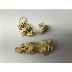 Three carved Tokyo style okimono, 19th century, one carved as a demon with monkeys on his back, with two others carved as men at work, largest example L9.5cm