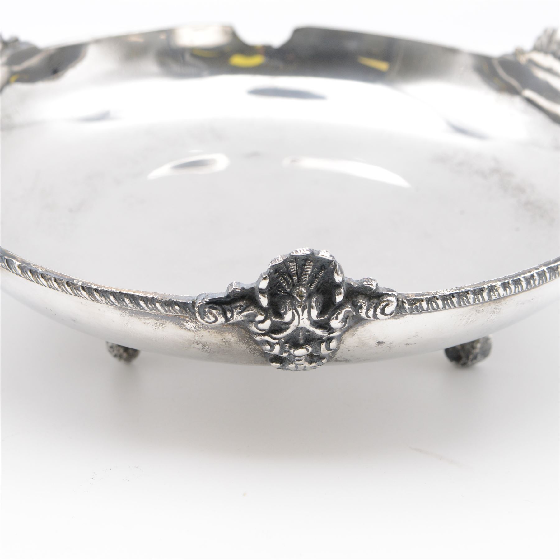 Egyptian silver bowl, of circular form, with oblique gadrooned rim and cast palmette decoration, upon three scroll feet, marked for 900 fineness, D20cm