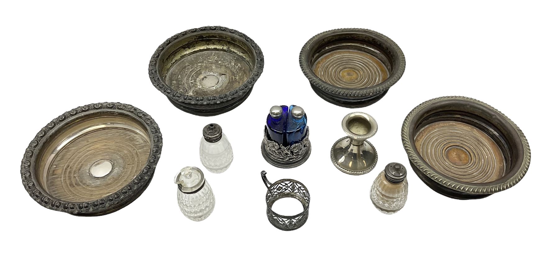 Four 19th century silver plated wine bottle coasters, together with hallmarked silver collared and lidded glass cruet trio and ornate silver cruet holder missing liner, with handle, and other silver plate etc
